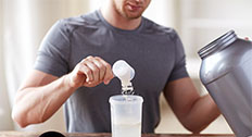 Man placing supplement in container