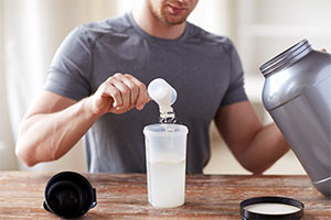 Man placing supplement in container